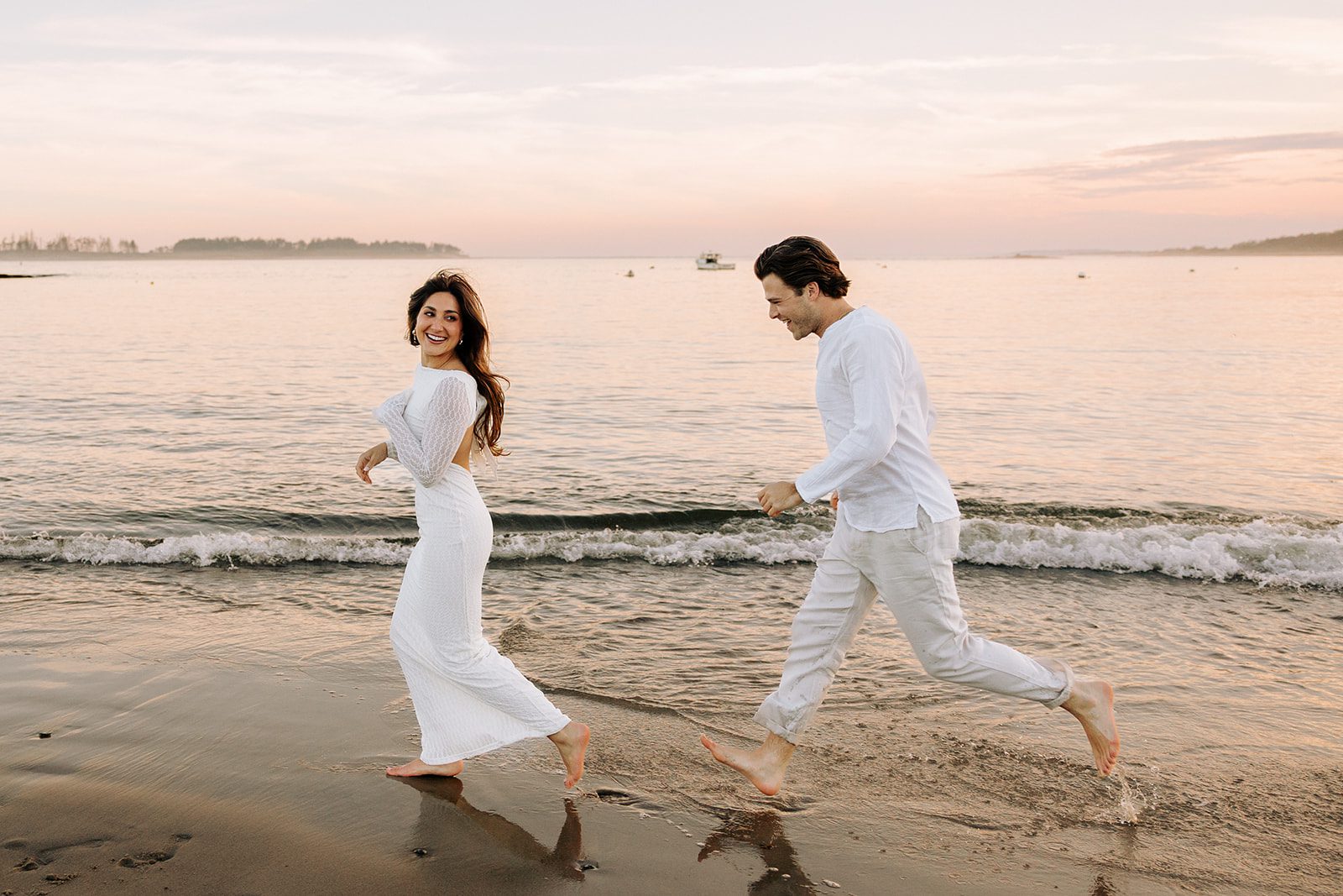 Joyful engagement session at Kettle Cove Cape Elizabeth Maine with ocean views and golden hour light