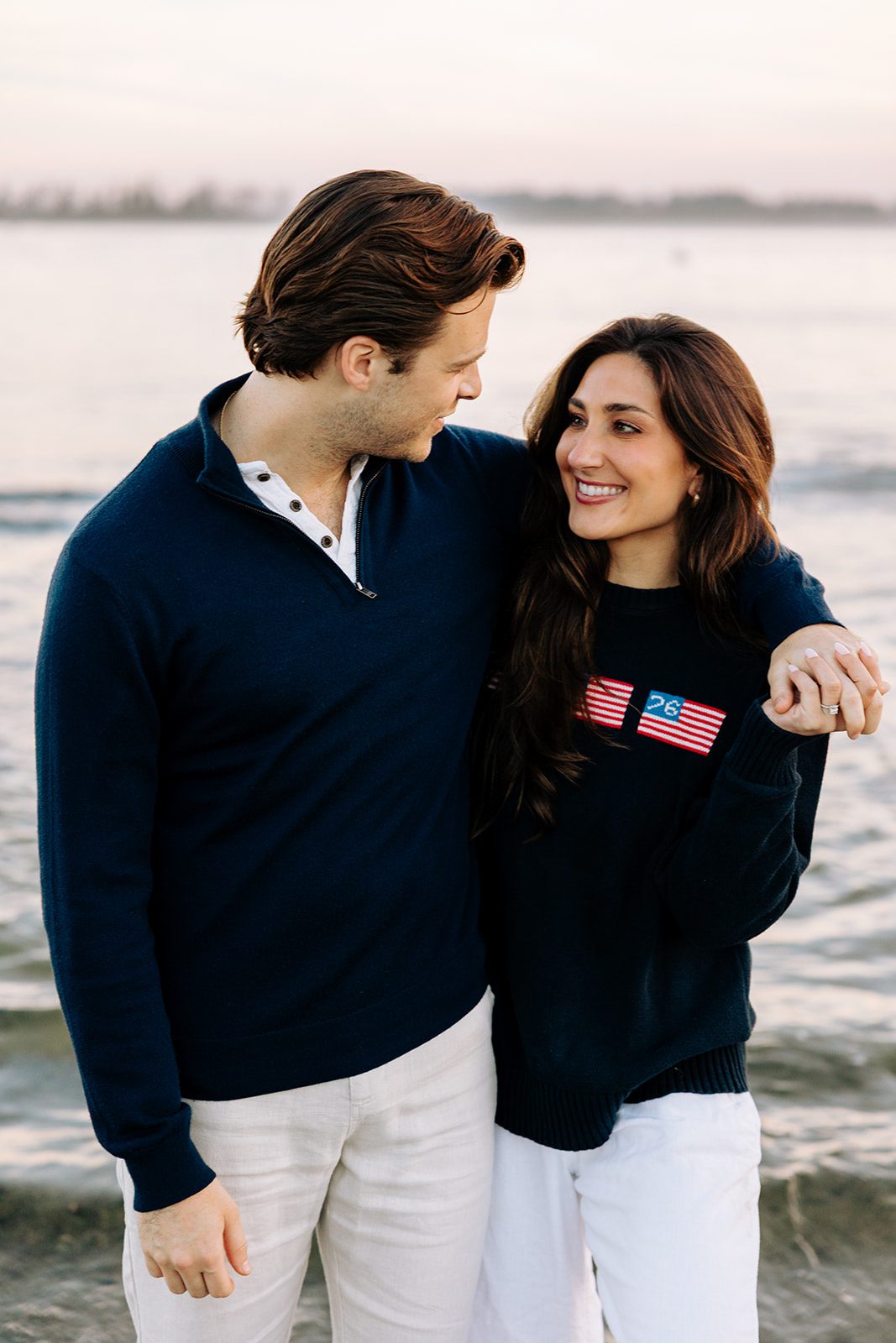 Intimate engagement photo of couple walking along beach path in Cape Elizabeth Maine